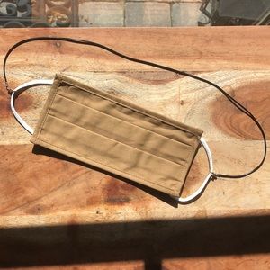 Tan/nude face mask with black mask chain